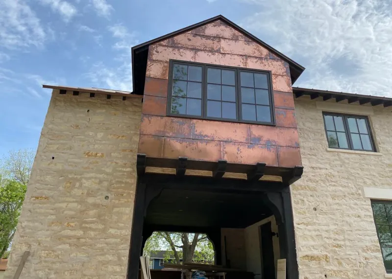 Copper metal panel facade on a stone building for Roof Repair in Tellico Village