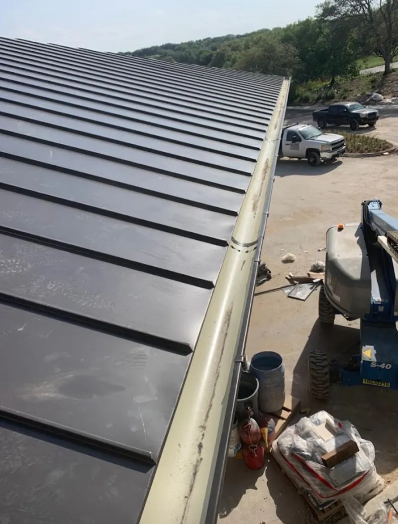 Standing seam panel and gutter detail on a metal roofing jobsite in Tellico Village